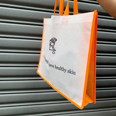Túi vải không dệt viền cam in logo theo yêu cầu