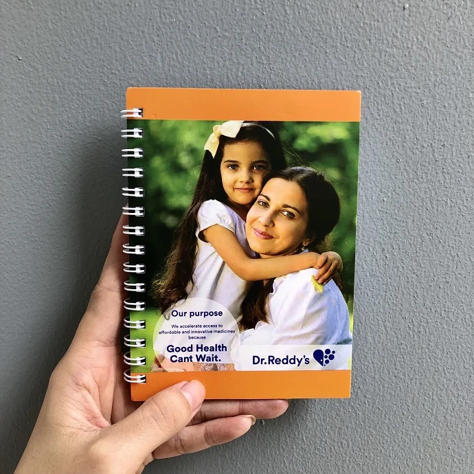 Sổ Tay Lò Xo Dr. Reddy’s – Sổ Ghi Chép Quà Tặng Doanh Nghiệp Bìa Cam Hình Mẹ & Bé